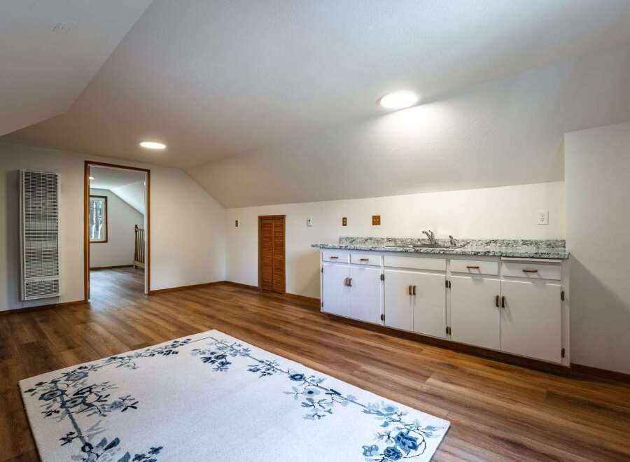 Discover this charming attic space, perfect for a home office or guest suite.