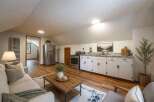 Discover this charming studio apartment featuring a compact kitchen with white cabinetry and granite countertops, perfect for preparing meals.