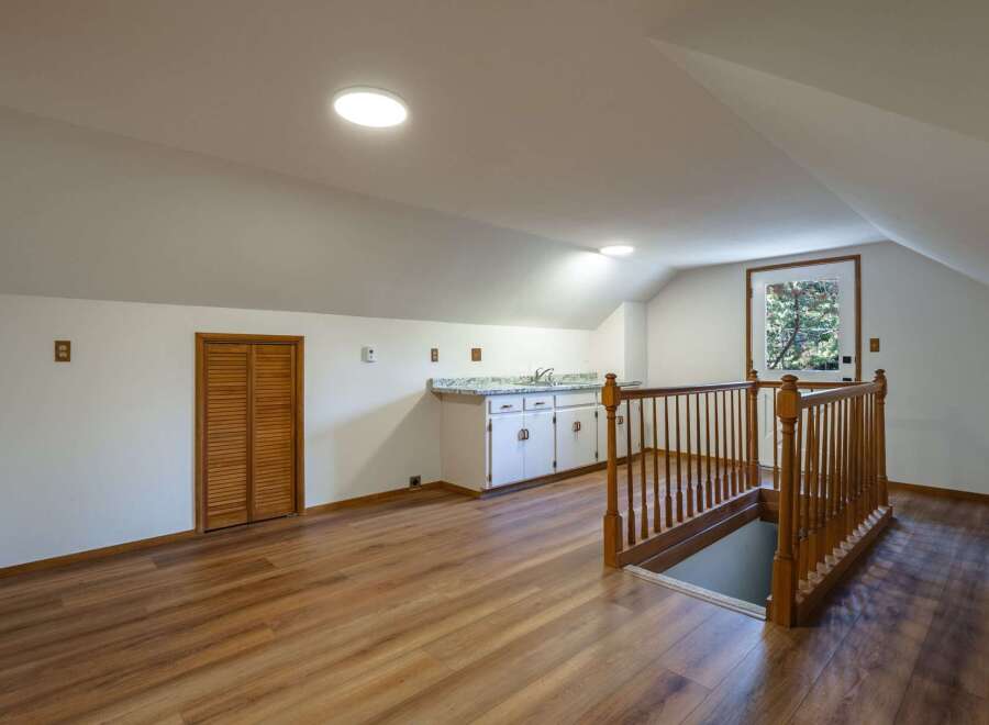 Discover this charming attic space, perfect for a home office or guest suite.