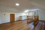 Discover this charming attic space, perfect for a home office or guest suite.
