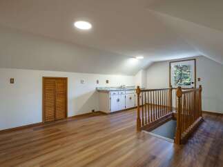 Discover this charming attic space, perfect for a home office or guest suite.
