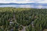 Nestled within a dense forest of mature pine trees, this property offers a secluded retreat with stunning lake views in the distance.