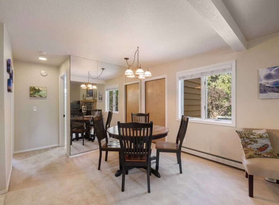 This dining area features a round wooden table with four matching chairs, perfect for intimate meals.