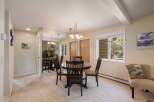 This dining area features a round wooden table with four matching chairs, perfect for intimate meals.