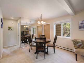 This dining area features a round wooden table with four matching chairs, perfect for intimate meals.
