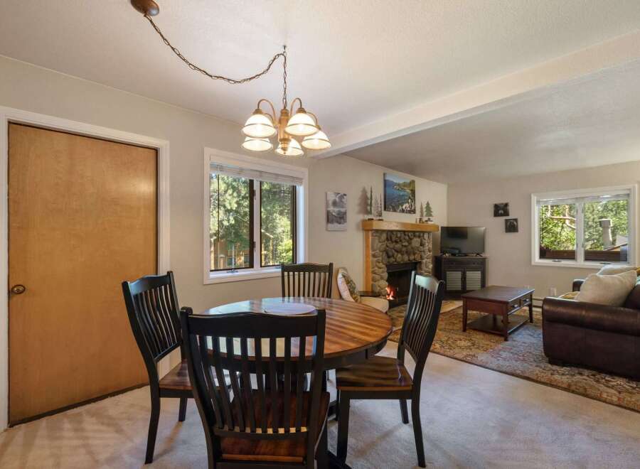 Cozy dining area with a round wooden table and four chairs, perfect for intimate meals.