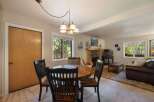 Cozy dining area with a round wooden table and four chairs, perfect for intimate meals.