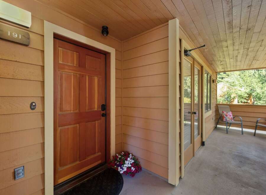Welcome to this charming property featuring a warm and inviting entryway with a classic wooden door and a welcoming porch.