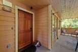 Welcome to this charming property featuring a warm and inviting entryway with a classic wooden door and a welcoming porch.