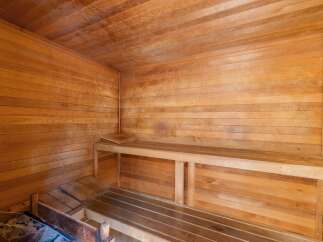 Experience ultimate relaxation in this beautifully crafted wooden sauna.