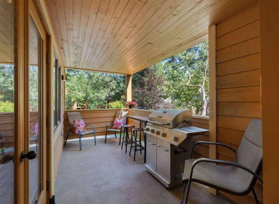 Enjoy outdoor living on this covered patio, complete with a gas grill for summer barbecues.
