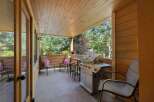 Enjoy outdoor living on this covered patio, complete with a gas grill for summer barbecues.