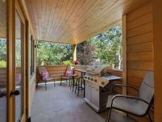 Enjoy outdoor living on this covered patio, complete with a gas grill for summer barbecues.