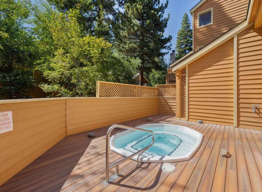 Relax and unwind in your private outdoor spa area, featuring a luxurious hot tub perfect for soaking under the sun or stars.