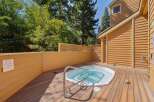 Relax and unwind in your private outdoor spa area, featuring a luxurious hot tub perfect for soaking under the sun or stars.