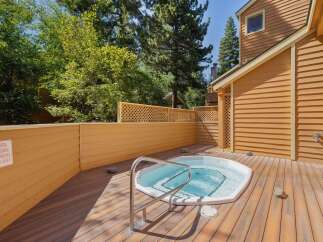 Relax and unwind in your private outdoor spa area, featuring a luxurious hot tub perfect for soaking under the sun or stars.