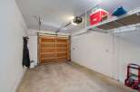 This spacious garage offers ample storage with overhead shelving, perfect for keeping your belongings organized and out of the way.