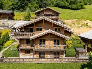 Experience luxury mountain living in this stunning multi-level chalet, featuring exquisite wooden architecture and expansive balconies offering breathtaking views.