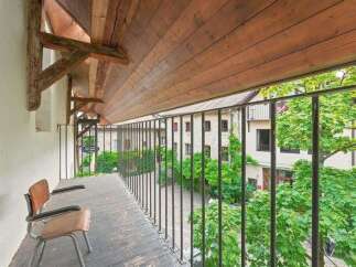 Enjoy the charm of this historic property with a covered balcony overlooking a picturesque courtyard.