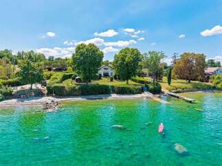 Experience serene lakeside living with this stunning property featuring direct water access and a private dock.