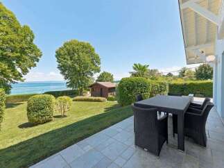 Enjoy breathtaking lake views from this stunning property, featuring a spacious patio perfect for outdoor dining and relaxation.