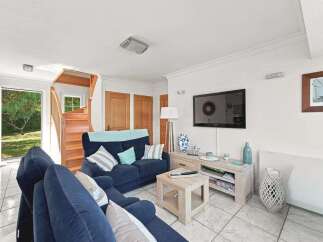 Step into this inviting living room featuring a comfortable navy blue sectional sofa, perfect for relaxing evenings.