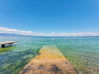 Enjoy a refreshing dip in the crystal-clear waters of this stunning lakefront property.