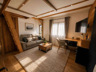 Experience cozy living in this charming room featuring a comfortable leather sofa and a rustic wooden coffee table, perfect for relaxation.