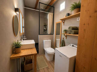 Discover this charming bathroom featuring a modern vessel sink atop a rustic wooden vanity, complemented by a sleek glass-enclosed shower.