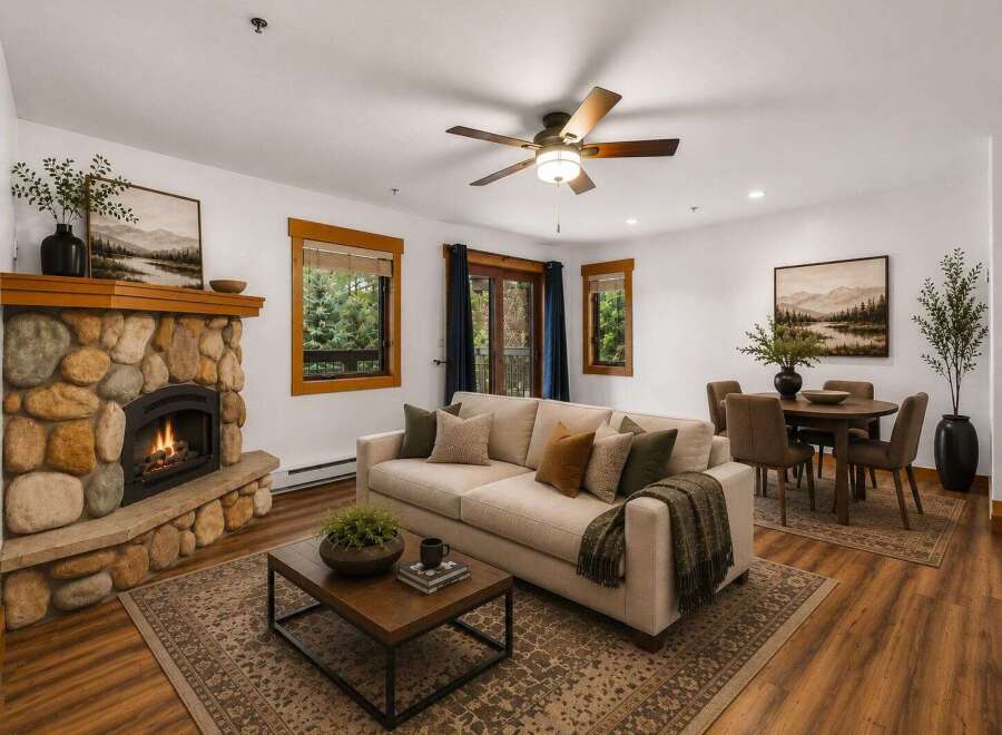 Cozy living room featuring a striking stone fireplace and a comfortable sofa, perfect for relaxing evenings.