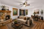 Cozy living room featuring a striking stone fireplace and a comfortable sofa, perfect for relaxing evenings.