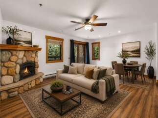 Cozy living room featuring a striking stone fireplace and a comfortable sofa, perfect for relaxing evenings.