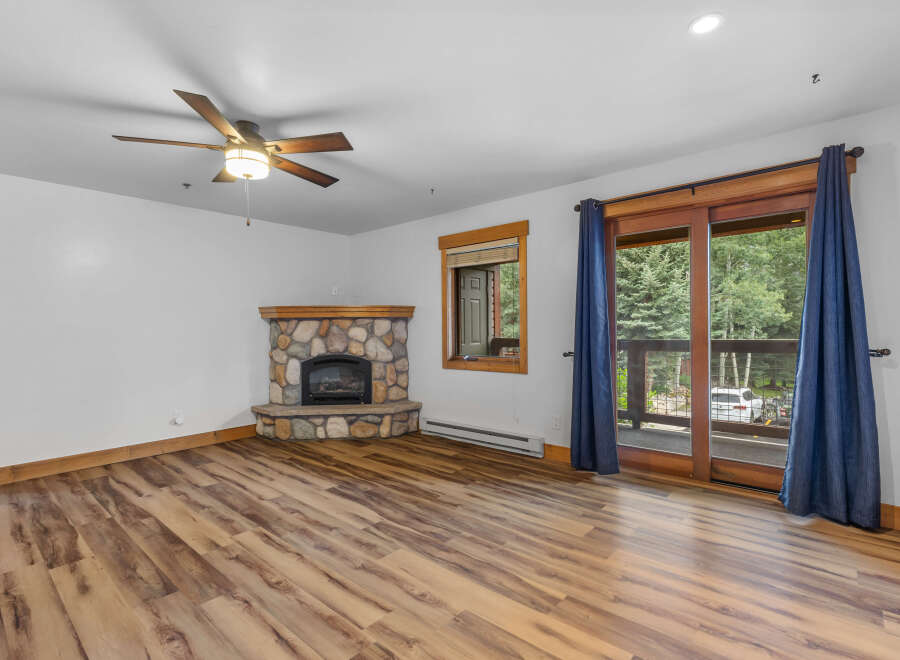 Cozy living room featuring a stone-faced fireplace, perfect for chilly evenings.