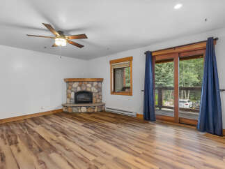 Cozy living room featuring a stone-faced fireplace, perfect for chilly evenings.