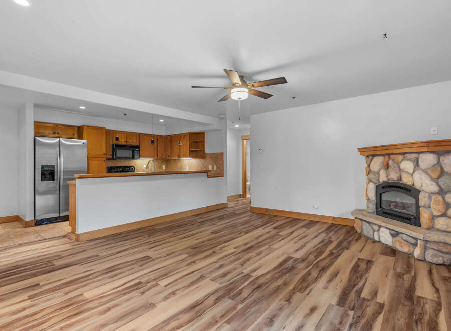 Experience cozy living in this charming space featuring a rustic stone fireplace, perfect for gathering on cool evenings.