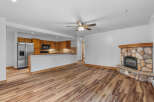 Experience cozy living in this charming space featuring a rustic stone fireplace, perfect for gathering on cool evenings.