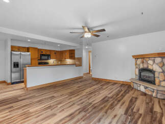 Experience cozy living in this charming space featuring a rustic stone fireplace, perfect for gathering on cool evenings.