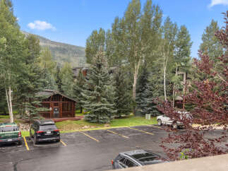 Nestled amidst lush greenery and mature trees, this property offers a serene mountain retreat.