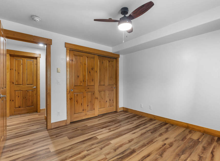Step into this inviting room featuring a warm wooden interior and a stylish ceiling fan.