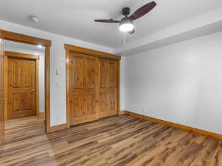 Step into this inviting room featuring a warm wooden interior and a stylish ceiling fan.