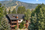 Experience mountain living in this charming property nestled amidst lush greenery and overlooking scenic ski slopes.