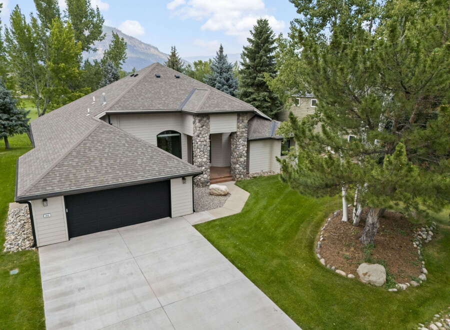 Discover this stunning home featuring a striking stone-accented entrance and a spacious attached garage.
