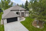 Discover this stunning home featuring a striking stone-accented entrance and a spacious attached garage.