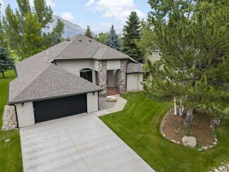 Discover this stunning home featuring a striking stone-accented entrance and a spacious attached garage.