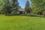 Enjoy the spacious backyard with lush green grass, perfect for outdoor activities and relaxation.