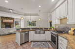 This spacious kitchen boasts a large stainless steel farmhouse sink, perfect for any culinary enthusiast.