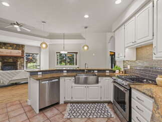 This spacious kitchen boasts a large stainless steel farmhouse sink, perfect for any culinary enthusiast.