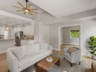 Experience modern living in this beautifully appointed open-concept home, featuring a sleek kitchen with stainless steel appliances and ample cabinet space.
