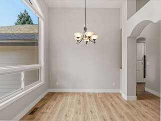 Experience spacious living in this bright dining area, featuring a large bay window that floods the room with natural light.