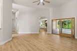 Step into this inviting living space featuring high vaulted ceilings and a modern ceiling fan for optimal comfort.